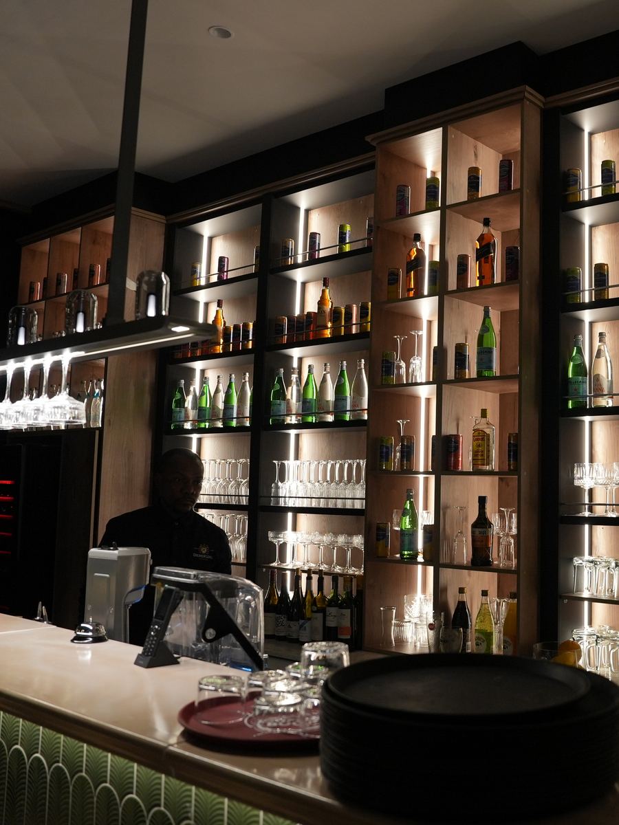 The Avero bar, backlit shelves of bottles and glassware